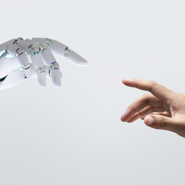 A robotic hand and a human hand getting closer